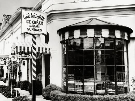 Wil Wright’s storefront with curved glass windows and striped awnings.
