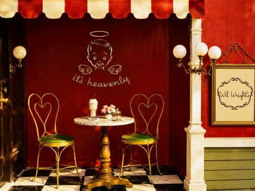 Wil Wright’s seating area with angel illustration and striped awning.