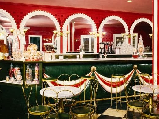 Wil Wright’s vintage interior with marble counter, brass seating, and candy jars.
